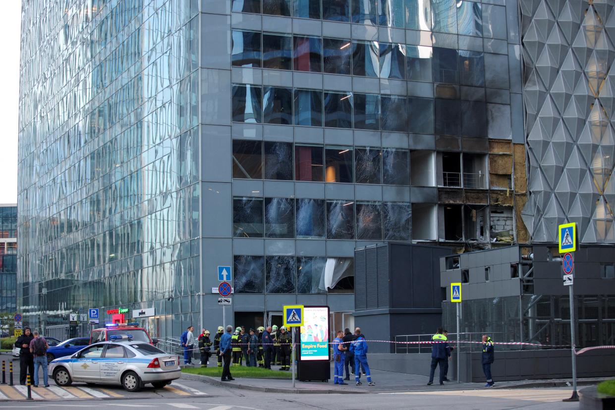 Emergencies services members gather outside the damaged office building in the Moscow City following a reported Ukrainian drone attack in Moscow (REUTERS)