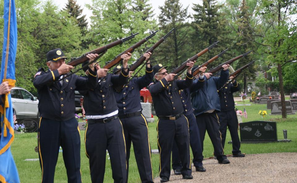 Members of the Sidney L. Smith Post 24 of the America Legion complete a 21-gun salute Monday during the Memorial Day service at St. Mary's Cemetery in Aberdeen.