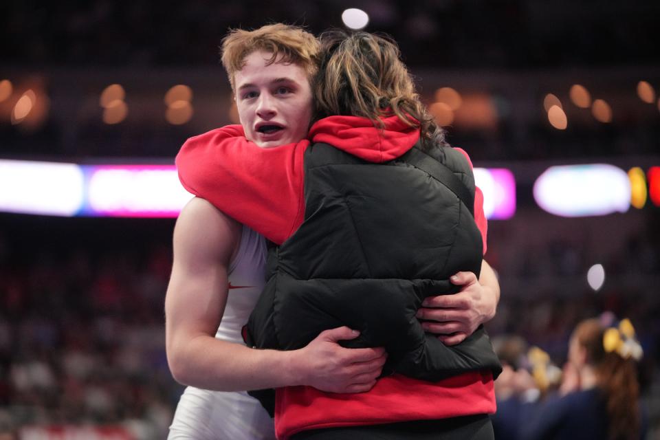 Iowa City High's Cale Seaton hugs his mother Amber after winning the 3A-132 final on Feb. 17 at Wells Fargo Arena.