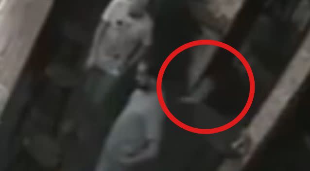 The little 'ghost' the men don't notice run past them. Photo: YouTube