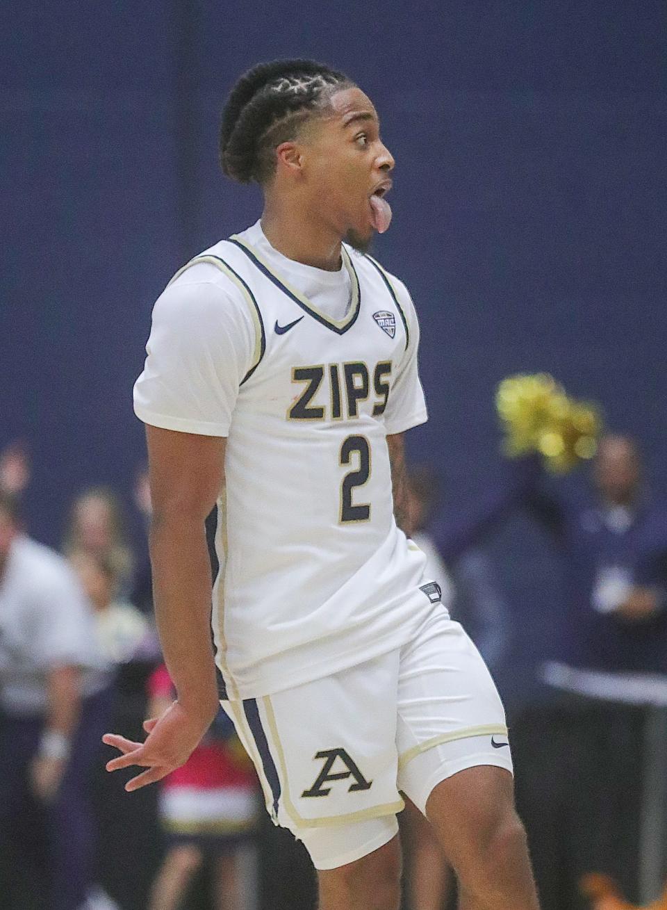 University of Akron's Greg Tribble gestures to the Zips student body after sinking a 3-pointer late in a win over Southern Miss on Friday in Akron.