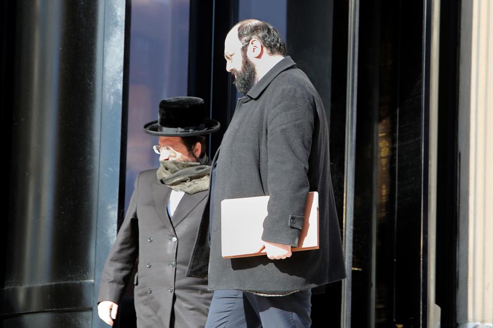 Rabbi Yehuda Oshry, left, and his attorney leave United States District Court in White Plains Feb. 27, 2020.