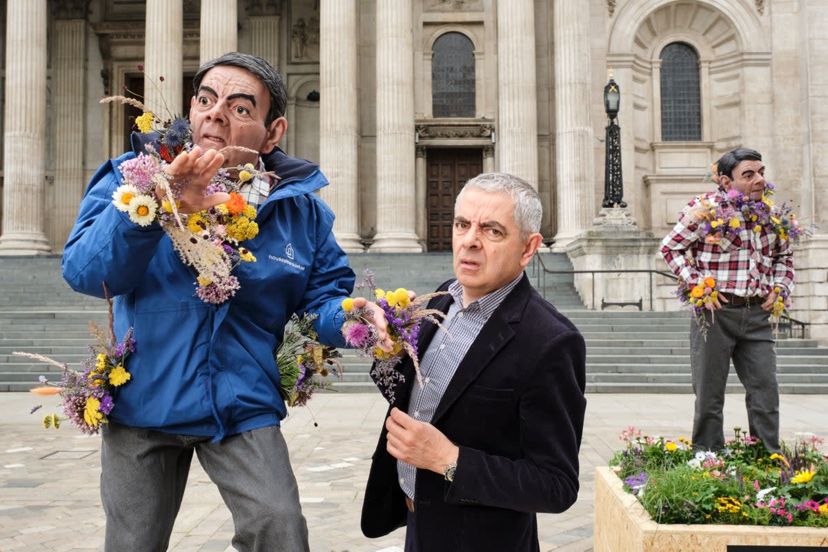 Rowan Atkinson has posed with giant flower sculptures made in his likeness to raise awareness of how to help endangered British bees (Hope&Glory)