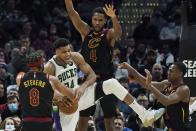 Cleveland Cavaliers' Lamar Stevens (8) strips the ball from Milwaukee Bucks' Giannis Antetokounmpo (34) under pressure from Evan Mobley (4) and Rajon Rondo (1) in the second half of an NBA basketball game, Wednesday, Jan. 26, 2022, in Cleveland. The Cavaliers won 115-99. (AP Photo/Tony Dejak)