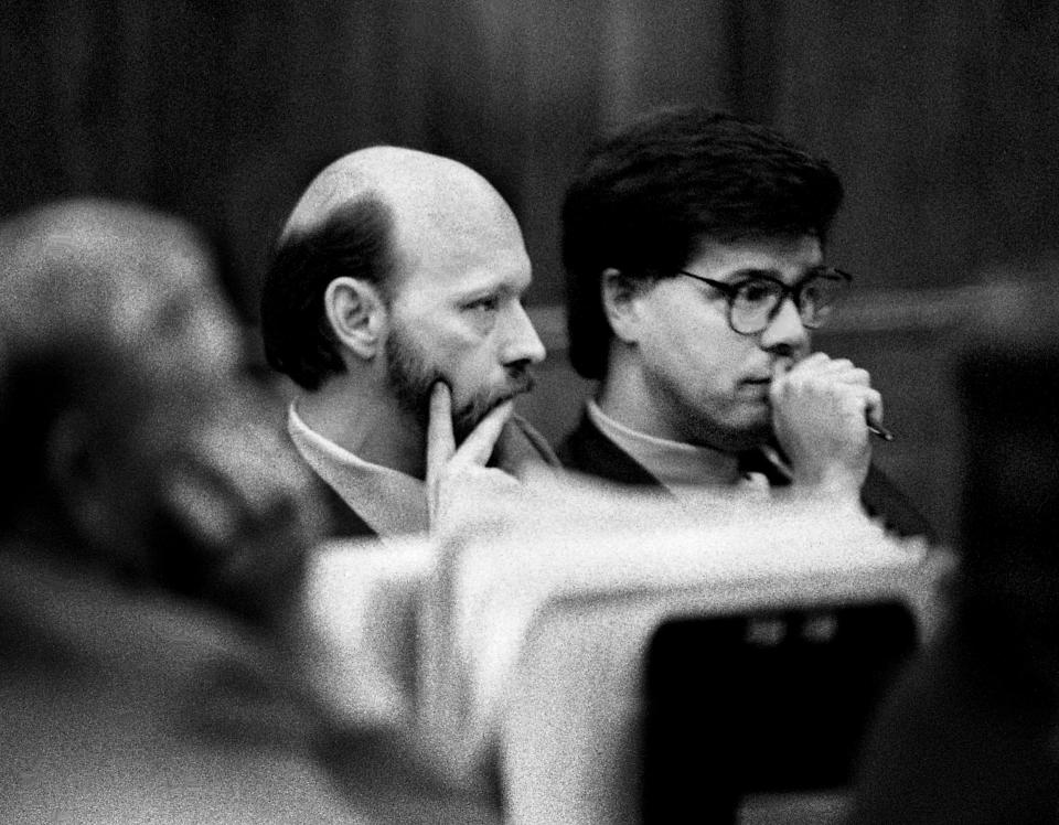 Oscar Franklin Smith, left, who is accused of shooting and stabbing his estranged wife, Judith Smith, and her two teenage sons, Chad and Jason Burnett, to death, listens to testimony with one of his attorneys, Metro Public Defender-elect Karl Dean, in his trial at Metro Courthouse July 24, 1990.