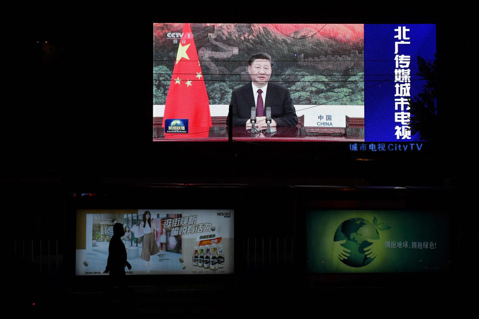 Image: An image of Chinese President Xi Jinping appearing by video link at the United Nations 75th anniversary is seen on an outdoor screen as a pedestrian walks past below in Beijing. (Greg Baker / AFP - Getty Images file)