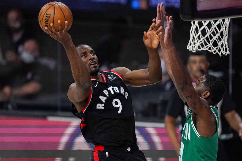 Toronto Raptors center Serge Ibaka (9) shoots over Boston Celtics guard Brad Wanamaker (9) during the first half of an NBA conference semifinal playoff basketball game Wednesday, Sept. 9, 2020, in Lake Buena Vista, Fla. (AP Photo/Mark J. Terrill)