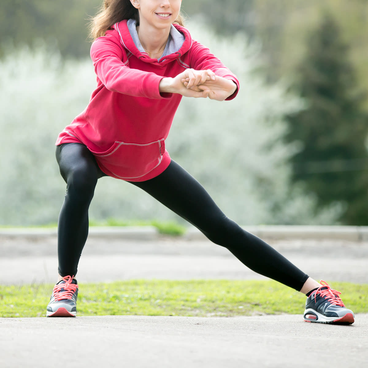 woman stretching in park