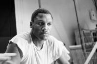 FILE - In this Feb. 3, 1970, file photo, Joe Frazier pauses after a workout at New Yorkís Madison Square Garden. Frazier, the former heavyweight champion who handed Muhammad Ali his first defeat yet had to live forever in his shadow, has died after a brief final fight with liver cancer. He was 67. The family issued a release confirming the boxer's death on Monday night, Nov. 7, 2011. (AP Photo/Marty Lederhandler, File)