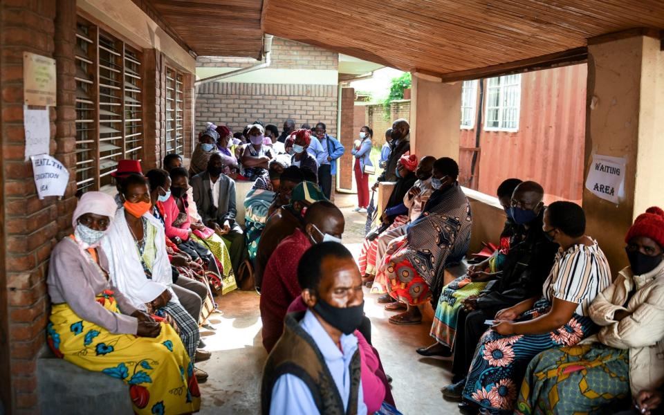 People wait to receive the AstraZeneca COVID-19 vaccine at Ndirande Health Centre in Blantyre Malaw - AP
