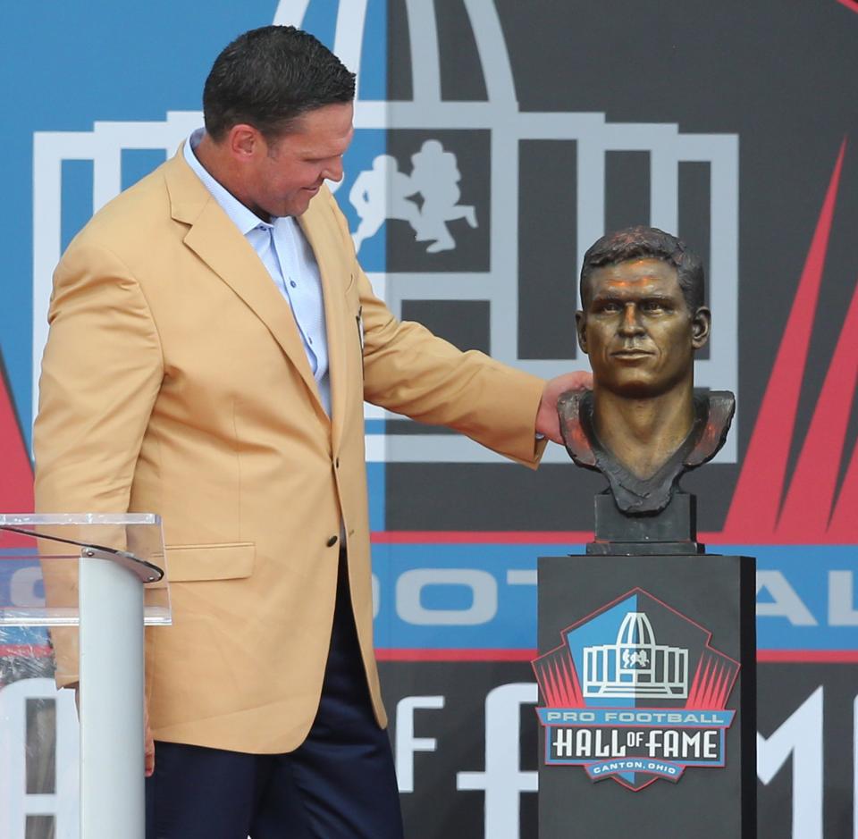 Tony Boselli admires his bust during the Pro Football Hall of Fame Enshrinement at Tom Benson Stadium in Canton on Saturday, August 6, 2022.