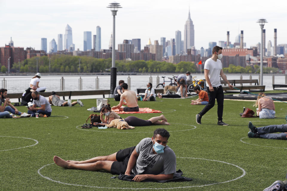 People relax in circles drawn to help social distancing at Domino Park in Brooklyn, New York. (Photo: ASSOCIATED PRESS)