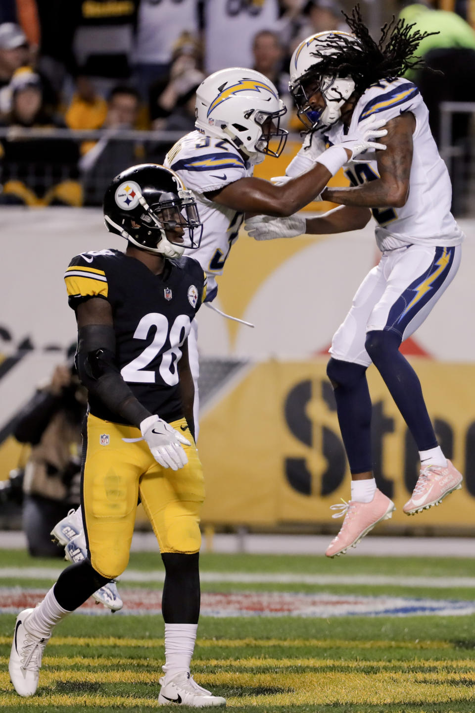Los Angeles Chargers wide receiver Travis Benjamin (12) celebrates with running back Justin Jackson (32) after scoring a touchdown past Pittsburgh Steelers cornerback Mike Hilton (28) in the first half of an NFL football game, Sunday, Dec. 2, 2018, in Pittsburgh. (AP Photo/Gene J. Puskar)