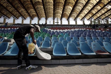 A worker repairs seats in an enclosure at the Gaddafi Stadium ahead of cricket series between Pakistan and Zimbabwe in Lahore, Pakistan, May 16, 2015. Zimbabwe's planned tour of Pakistan remained up in the air on Friday as discussions continued over whether they would become the first test-playing nation in six years to visit the south east Asian country. REUTERS/Mohsin Raza