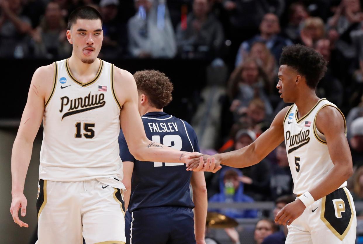 Purdue Boilermakers center Zach Edey (15) high-fives Purdue Boilermakers guard Myles Colvin (5) during NCAA MenÃ¢â‚¬â„¢s Basketball Tournament game against the Utah State Aggies, Sunday, March 24, 2024, at Gainbridge Fieldhouse in Indianapolis.