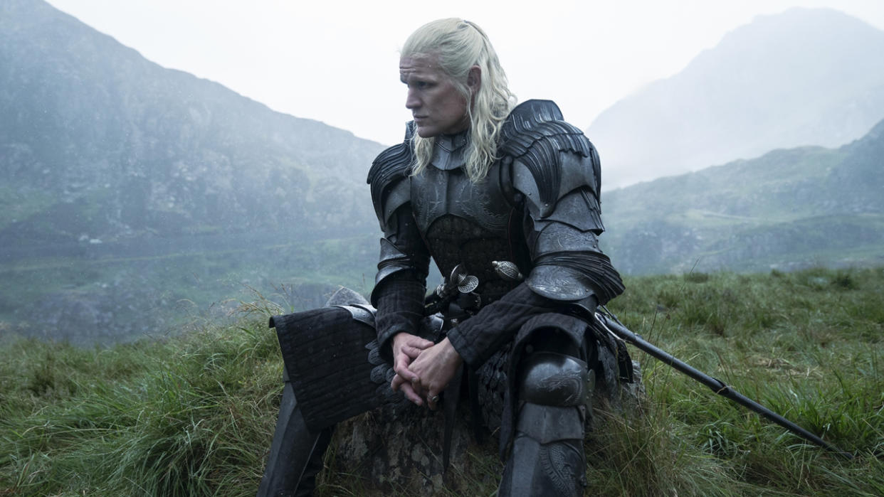  Daemon Targaryen sits in his armor in a leafy green area in House of the Dragon season 2. 