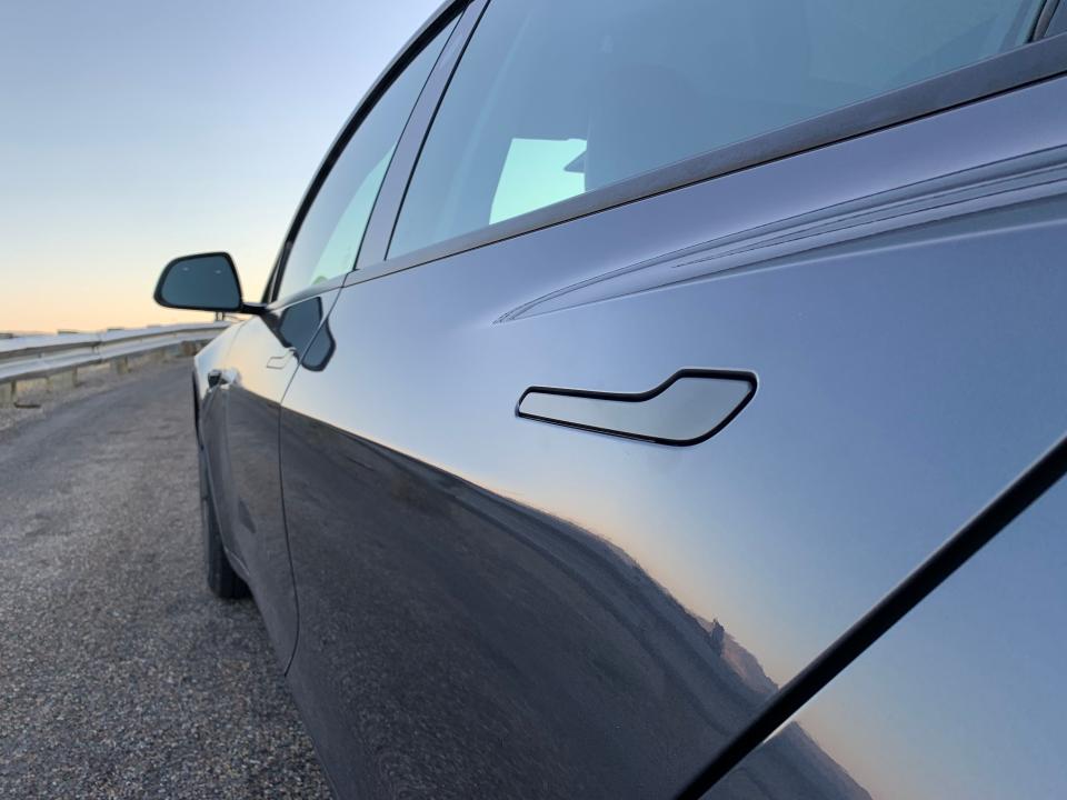 An up-close photo of a Tesla door handle.