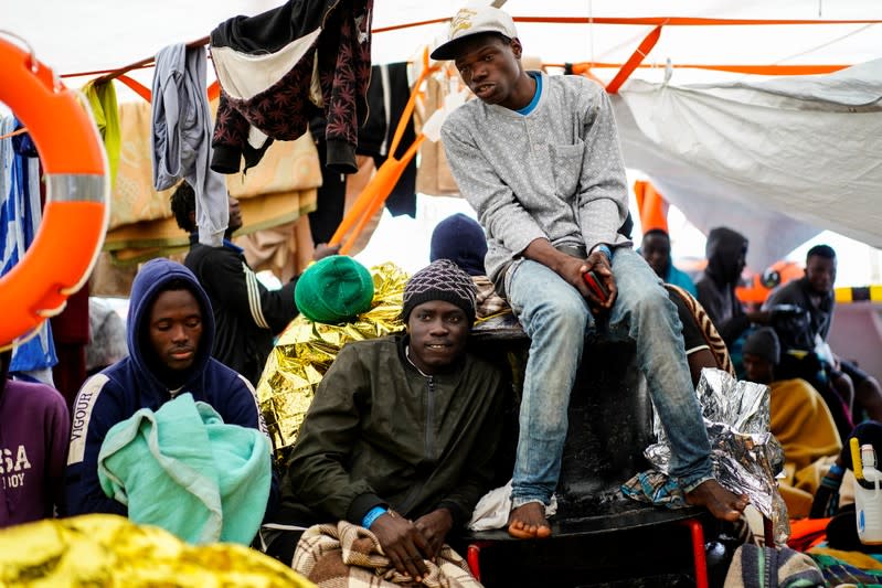 Migrants rest on board a NGO Proactiva Open Arms rescue boat in the central Mediterranean Sea