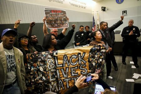 People carry a "Black Lives Matter" banner while protesting the death of Ezell Ford during a meeting of the Los Angeles Police Commission in Los Angeles, California June 9, 2015. REUTERS/Patrick T. Fallonâ€¨