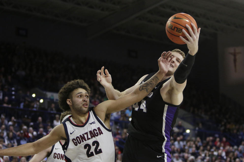 Gonzaga forward Anton Watson (22) and Portland center Joey St. Pierre (44) go after a rebound during the first half of an NCAA college basketball game Saturday, Jan. 14, 2023, in Spokane, Wash. (AP Photo/Young Kwak)