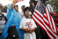 <p>Michael Claros, 8, of Silver Spring, Md., attends a rally in favor of immigration reform, Tuesday, Aug. 15, 2017, at the White House in Washington. The 8-year-old is a U.S. citizen whose parents would have been eligible for DAPA, or Deferred Action for Parents of Americans, an Obama-era policy memo that the Trump administration has since formally revoked. The protesters are hoping to preserve the program known as Deferred Action for Childhood Arrivals, or DACA. The Trump administration has said it still has not decided the DACA program’s fate. (Photo: Jacquelyn Martin/AP) </p>