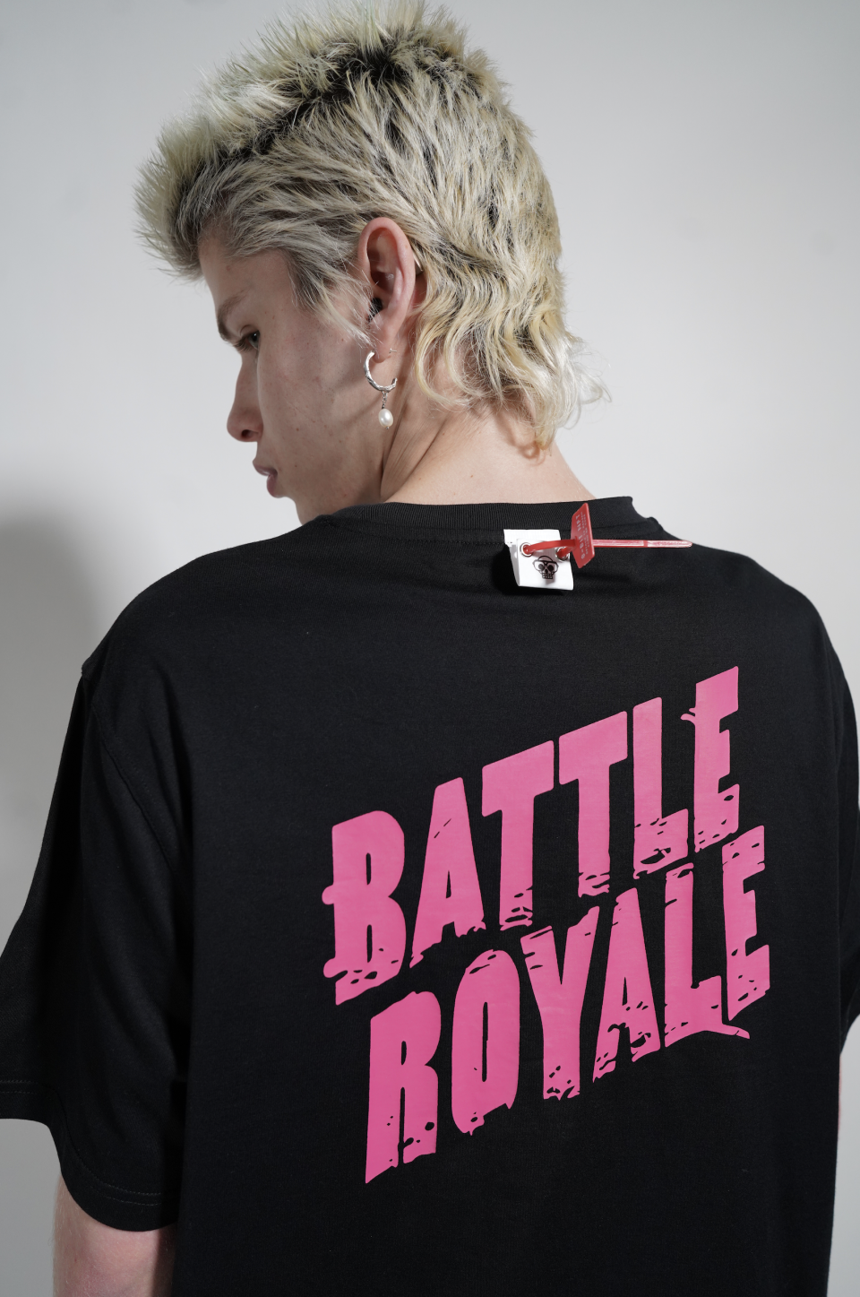 The “Battle Royale” shirt, with security tag in view. All of the items are tagged and feature a QR code that shuttles patrons into the metaverse. - Credit: Courtesy photo