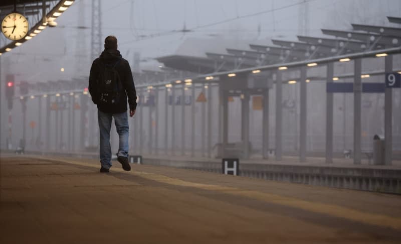 A man waits for a train at the main station.  The German Train Drivers' Union (GDL) has called for another 24-hour strike in the collective bargaining dispute at Deutsche Bahn for passenger and freight transport. Bernd Wüstneck/dpa