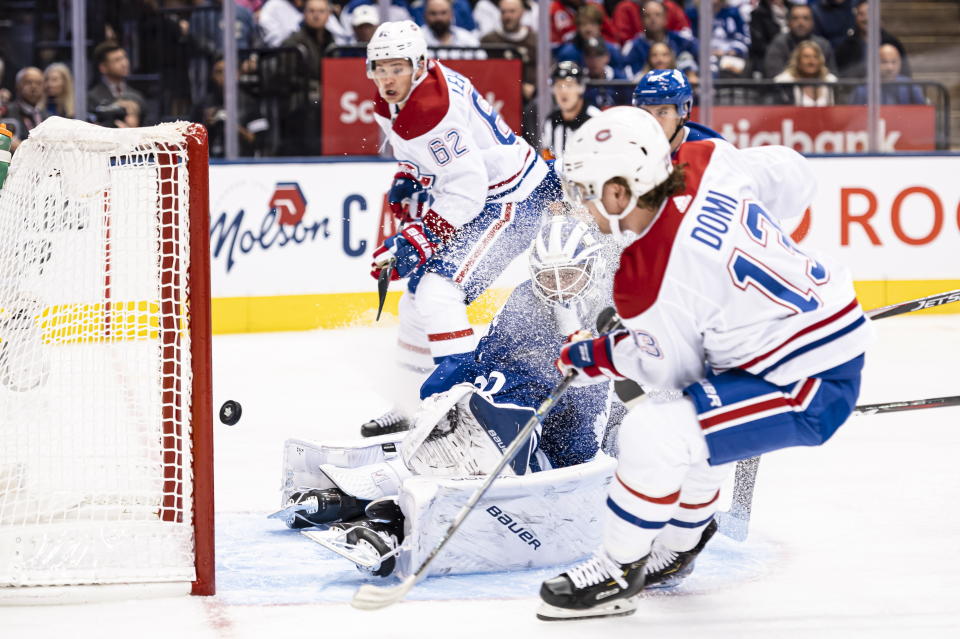 Montreal Canadiens centre Max Domi (13) scores on Toronto Maple Leafs goaltender Michael Hutchinson (30) during first period NHL action in Toronto, Saturday, Oct. 5, 2019. (Christopher Katsarov/The Canadian Press via AP)