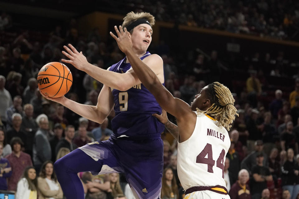 Washington guard Paul Mulcahy (9) looks to pass against Arizona State guard Adam Miller (44) during the first half of an NCAA college basketball game Thursday, Feb. 22, 2024, in Tempe, Ariz. (AP Photo/Darryl Webb)