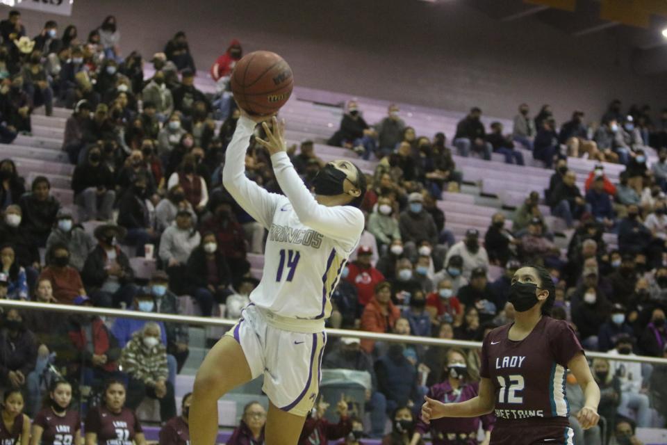 Kirtland Central's Jaylene Harris-Rhea makes her way to the basket past Shiprock's Kirsten Kelewood in the second quarter of their district basketball playoff game, Wednesday, Feb. 23, 2022 at Bronco Arena.
