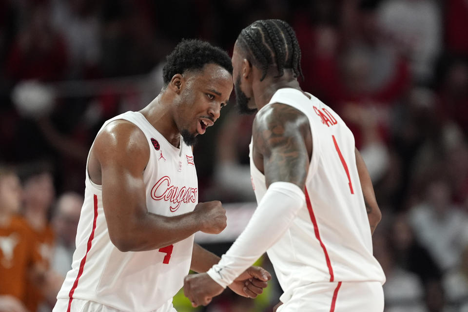 Houston's L.J. Cryer, celebrates with Jamal Shead after making a basket against Texas during the first half of an NCAA college basketball game Saturday, Feb. 17, 2024, in Houston. (AP Photo/David J. Phillip)