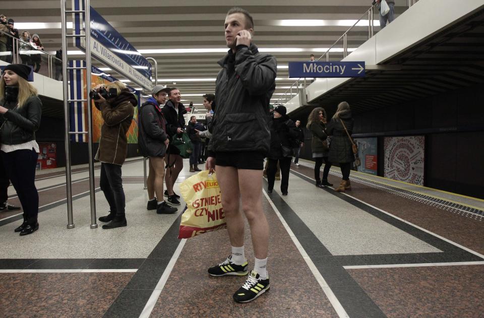 A passenger without his pants waits for a subway train during the "No Pants Subway Ride" event in Warsaw