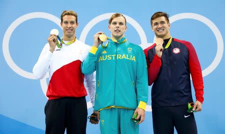 Rio Olympics - Swimming - Victory Ceremony - Men's 100m Freestyle Victory Ceremony - Olympic Aquatics Stadium - Rio de Janeiro, Brazil - 10/08/2016. Kyle Chalmers (AUS) of Australia, Pieter Timmers (BEL) of Belgium and Nathan Adrian (USA) of USA pose with their medals. REUTERS/David Gray