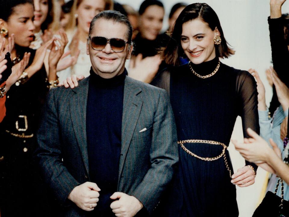 Karl Lagerfeld with model walk on runway at end of Chanel runway show