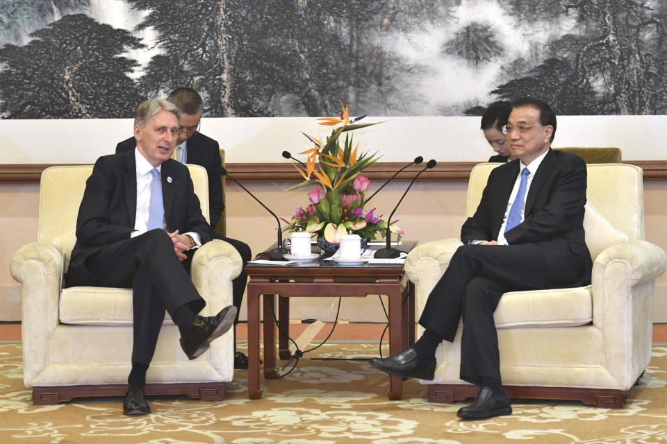 Britain's Chancellor of the Exchequer Philip Hammond, left, speaks with Chinese Premier Li Keqiang during their meeting at the Diaoyutai State Guesthouse, Friday, April 26, 2019, in Beijing. (Parker Song/Pool Photo via AP)