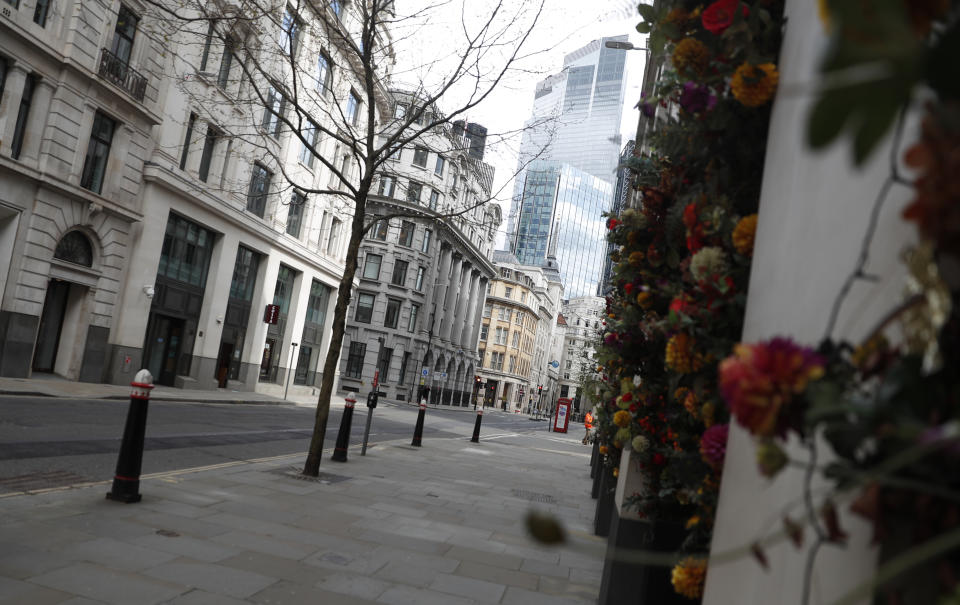 A view of Gresham street empty of traffic in the City of London, Tuesday, April 6, 2021. When the pandemic struck, about 540,000 workers vanished from London's financial hub almost overnight. The area known as "the City" became a ghost town as many people began working from home. A year on, most haven't returned to the business hub. (AP Photo/Alastair Grant)