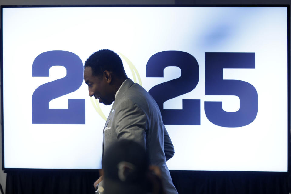 Atlanta Mayor Andre Dickens walks by a monitor displaying a 2025 logo before speaking during a press conference at Mercedes-Benz Stadium, Tuesday, Aug. 16, 2022, in Atlanta, announcing that the CFP National Championship NCAA college football game will be played at Mercedes-Benz Stadium in 2025. (Jason Getz/Atlanta Journal-Constitution via AP)