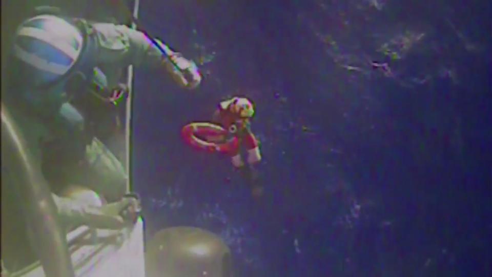 U.S. Coast Guard members retrieve a life preserver ring from the cargo ship El Faro in this still image from a October 4, 2015 U.S. Coast Guard handout video. Search and rescue teams on Sunday located debris which appeared to belong to the El Faro, which went missing in the eye of Hurricane Joaquin with 33 mostly American crew members aboard. (REUTERS/U.S. Coast Guard)