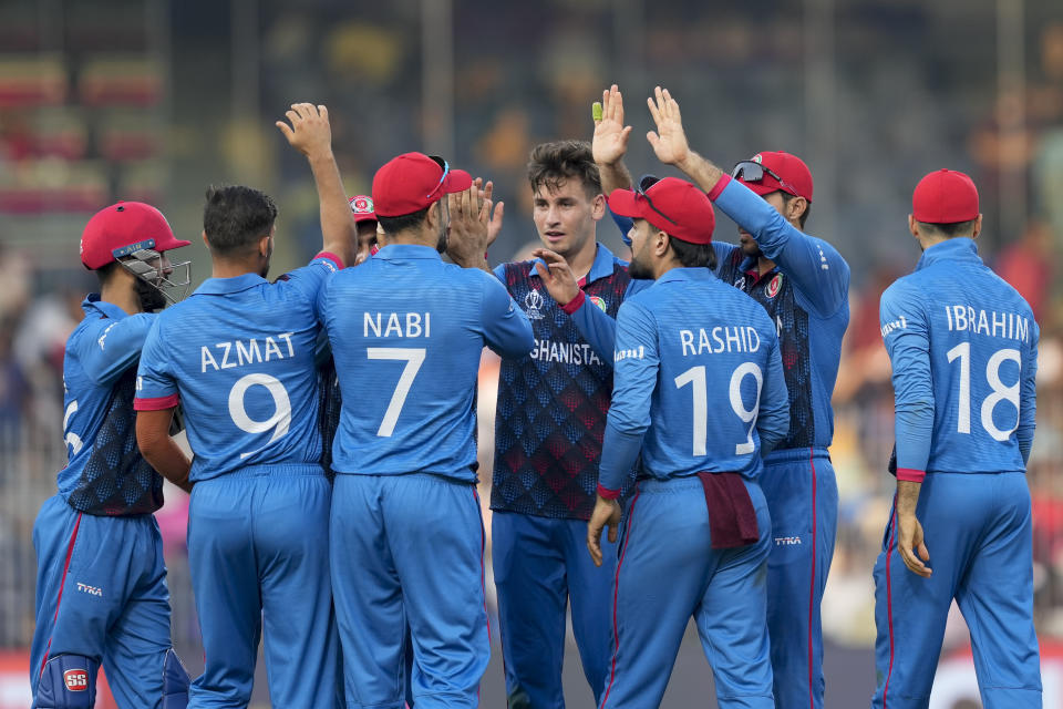 Afghanistan's Noor Ahmad, centre without cap, celebrates the dismissal of Pakistan's captain Babar Azam with his teammates during the ICC Men's Cricket World Cup match between Pakistan and Afghanistan in Chennai, India, Monday, Oct. 23, 2023. (AP Photo/Eranga Jayawardena)