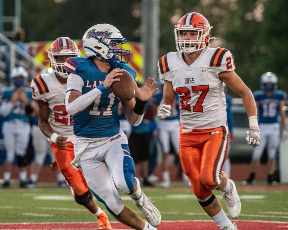 Heath's Tannar Patterson (27) pressures Lakewood's Adam Crawford during the Bulldogs' 48-7 victory last Friday. Patterson is the team's leading tackler on the season.