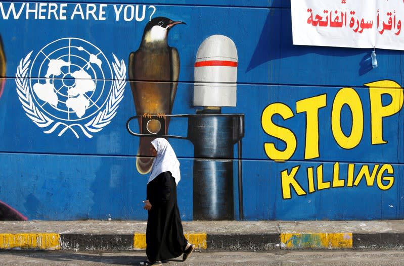 An Iraqi woman walks during the ongoing anti-government protests in Baghdad