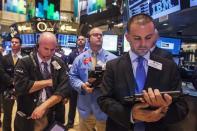 Traders pause during a moment of silence to honor victims of the 9/11 attacks on the World Trade Center, on the floor of the New York Stock Exchange September 11, 2013. (REUTERS/Lucas Jackson)