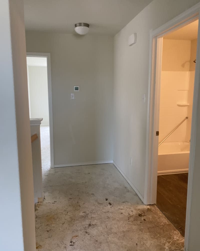 plain white door in white hallway before makeover