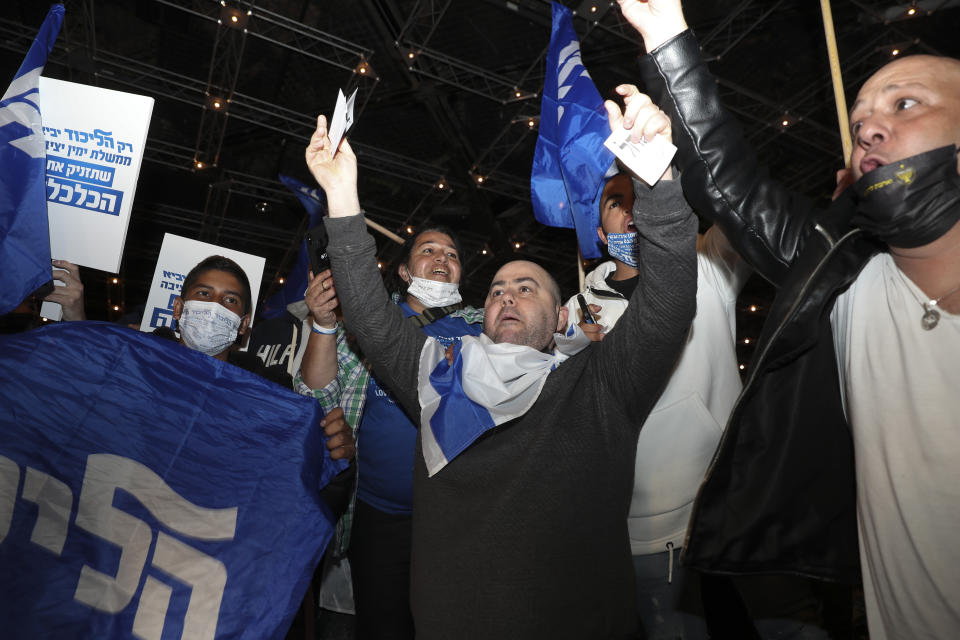 Israeli Prime Minister Benjamin Netanyahu's supporters celebrate after first exit poll results for the Israeli elections at his party's headquarters in Jerusalem, Tuesday, March. 23, 2021. (AP Photo/Ariel Schalit)