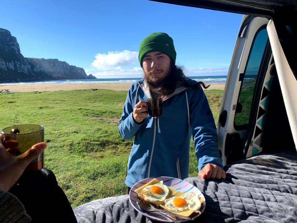 person eating eggs out of the back of a van