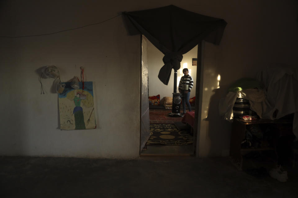 Roza Barakat poses for a portrait in a safe house in Hassakeh, Syria, Sunday, Feb. 6, 2022. Barakat was 11 years old when she was taken by IS militants, along with thousands of others, when the extremists overran her hometown of Sinjar in northwestern Iraq. Eight years later, she is living in the shadows, afraid to go home and fearing her community won't accept her. (AP Photo/Baderkhan Ahmad)