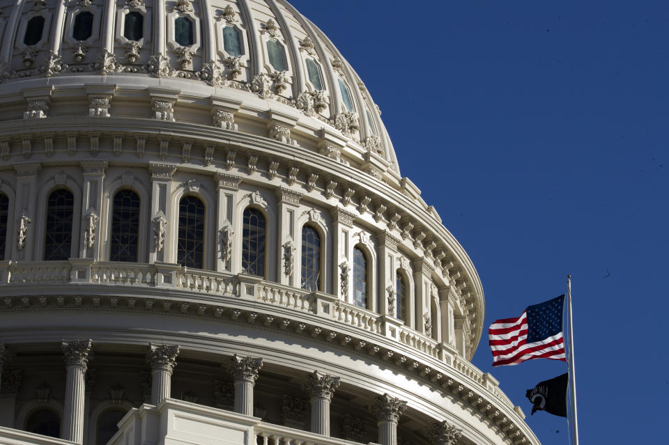 The U.S. flag flies over the U.S. Capitol in Washington, Sunday, Jan. 19, 2020. (AP Photo/Manuel Balce Ceneta)