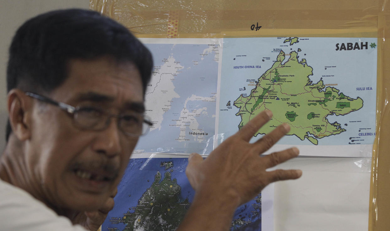 FILE PHOTO: Abraham Idjirani, spokesman for the Sultanate of Sulu, points at a map of Borneo's eastern Sabah state as he talks to reporters in suburban Taguig City, Philippines on Tuesday March 5, 2013. (AP Photo/Aaron Favila)