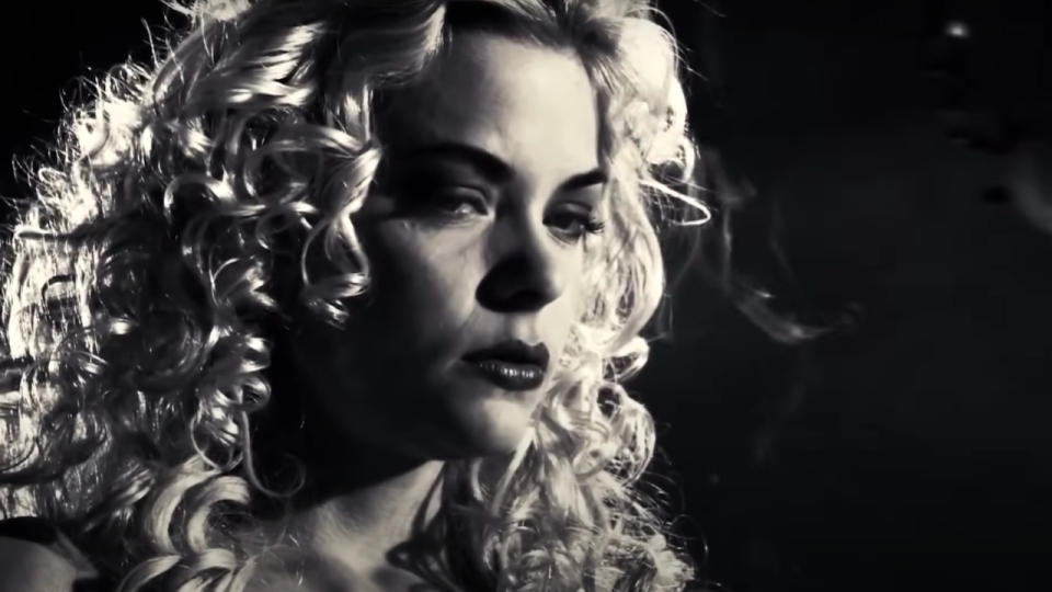 Jamie King glaring in a black and white scene in Sin City.