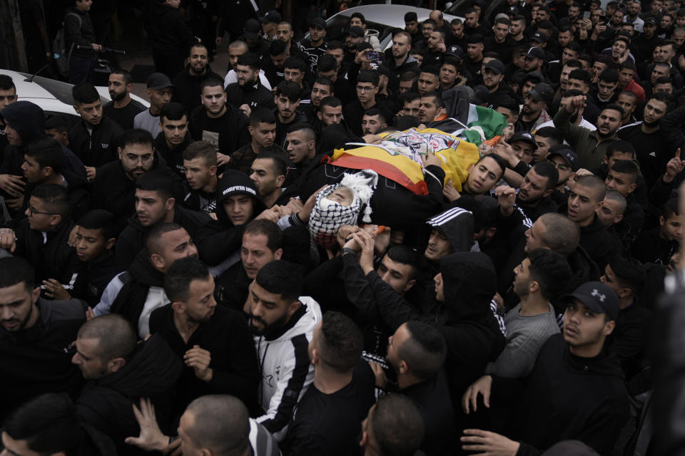 Palestinians attend the funeral of Mohammed Sherif Hassan Selmi in Qalqiliya, West Bank, Tuesday, Feb. 13, 2024. The Israeli army said that Salemi was shot and killed when he tried to overrun soldiers. (AP Photo/Majdi Mohammed)